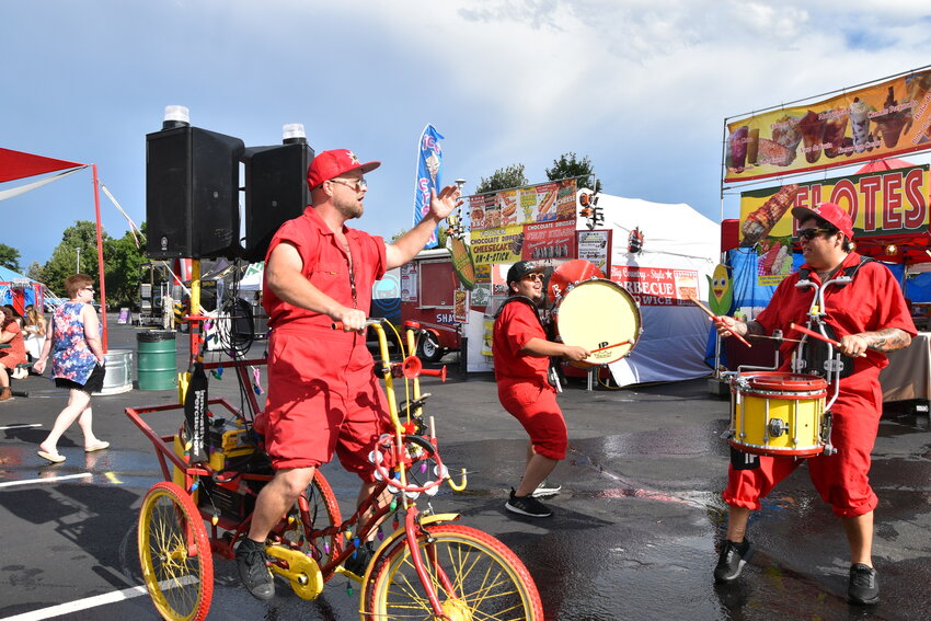 his group is called Boom, strolling around the fair with a bicycle modified with a boom box attached. They played 80's music, singing, drums, and dancing, entertaining the crowds on August 3.
